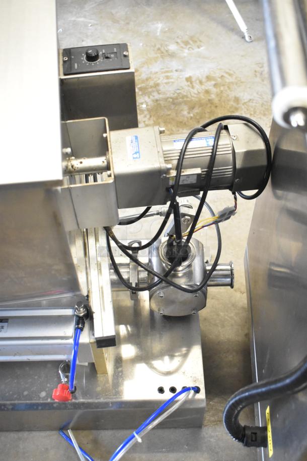 Commercial countertop meat mixer with foot pedal, featuring a durable metal body, visible wiring, and control panel.