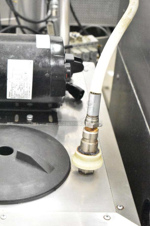 Frontline Commercial Fryer Oil Transport on casters, featuring a hose connection and motor. Metal surface with visible wear.