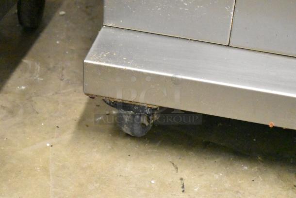 Fri-jado TDR7-P commercial rotisserie oven on casters. Visible corner detail, electric powered, 208V, 3 phase.