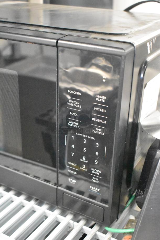 Mainstays MS8436193153-03 countertop microwave oven, black, keypad controls. 120 volts, 1 phase. Slight wear visible.