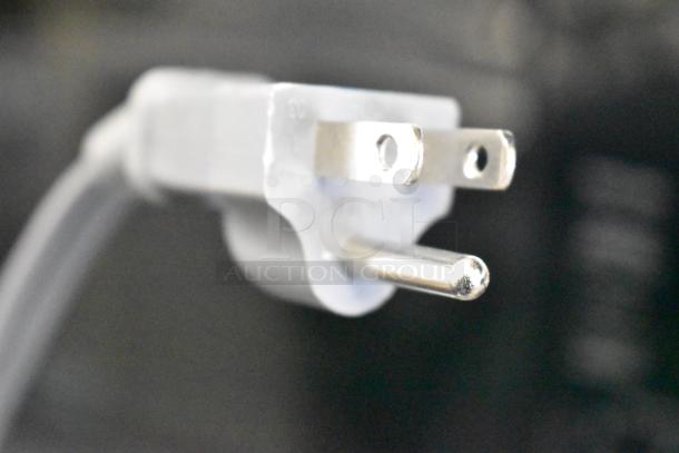 Close-up photo of the plug of a 2024 Mainstays MS8436193153-03 countertop microwave oven.