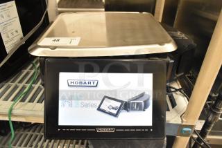 2017 Hobart HTi-7LH26 metal countertop food scale, tested and working, with digital display. 120/208-240V, 1 phase.