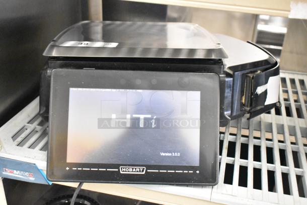 2017 Hobart HTi-7LH26 commercial scale, touchscreen display, tested, working, 120/208-240V, 1 phase, sleek black design.