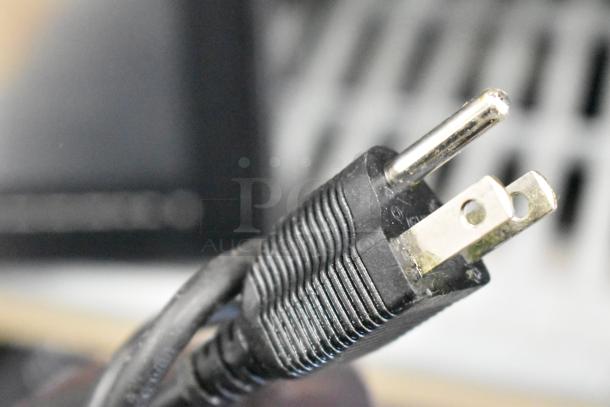 Close-up of the plug for a 2017 Hobart HTi-7LH26 food portioning scale, emphasizing its power compatibility.