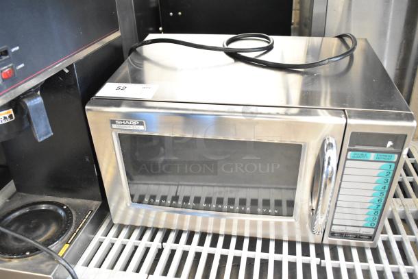 Sharp countertop microwave oven, 1000W, model R-21LV. Door stuck closed. 120V, 1 phase. Stainless steel exterior.