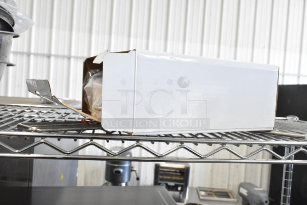 Three scales including a Detecto SCS30A hanging produce scale in a white box on a metal shelf, new condition.