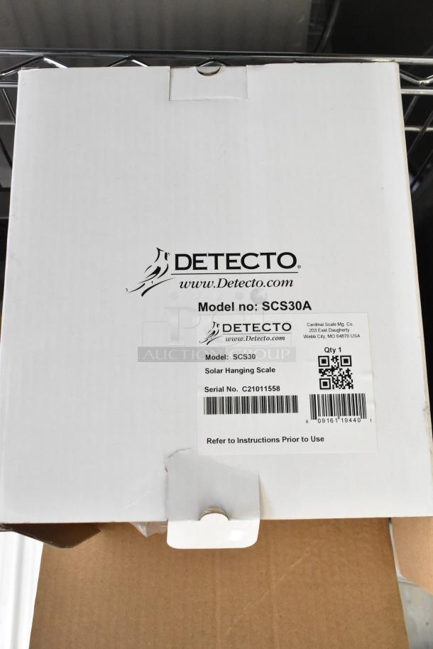 Detecto SCS30A Solar Hanging Scale box with model and serial number visible, in new condition.