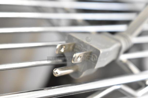 Close-up of a three-prong plug for a Hamilton Beach HB8436193153-09 countertop microwave, 120 volts, 1 phase.