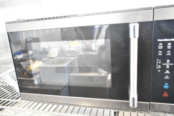 Hamilton Beach HB8436193153-09 countertop microwave oven, black, with control panel and chrome handle. 120V, 1 phase.