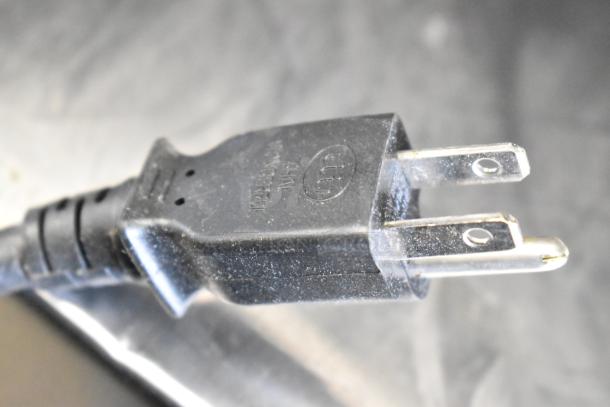 Alt text: Close-up of Sharp R-21LVF microwave plug showing UL certification marking.