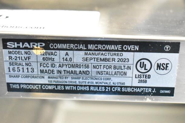 2023 Sharp R-21LVF Commercial Microwave Oven label showing model, serial number, certifications, and manufacturing details.