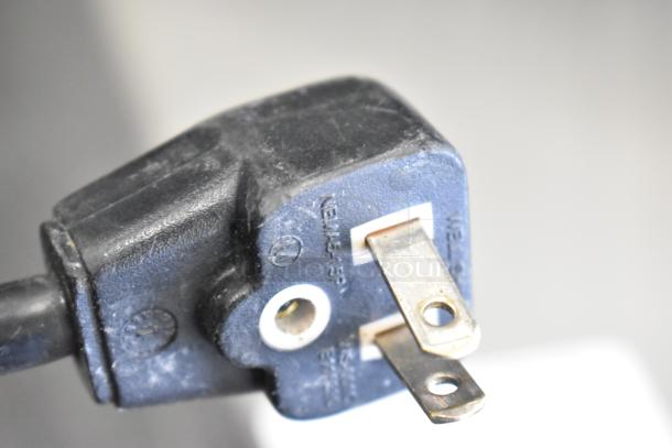 Amana RCS10MPA 120V commercial microwave plug showing intact prongs and original markings, indicating electrical details.