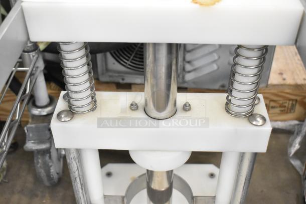 Countertop Pineapple Corer with stainless steel construction, visible springs, and sturdy design. Excellent condition.