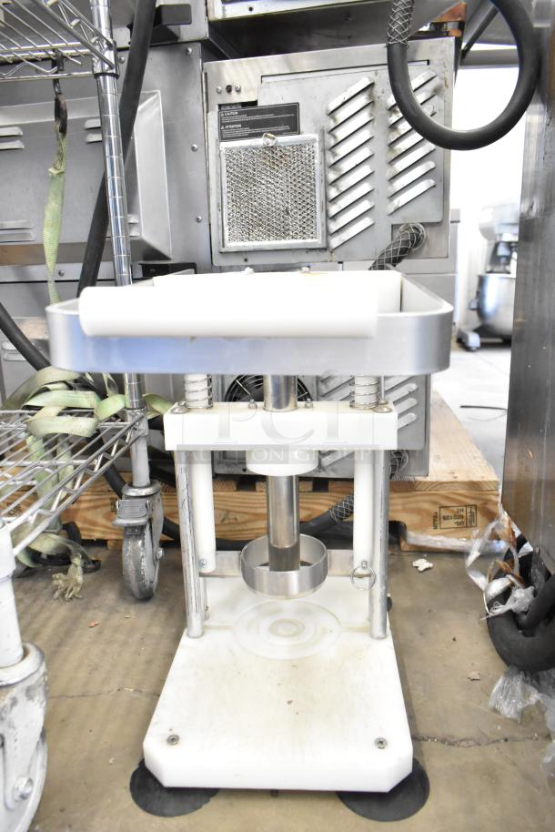 Countertop pineapple corer with stainless steel blade and sturdy base; used condition, ideal for efficient fruit processing.