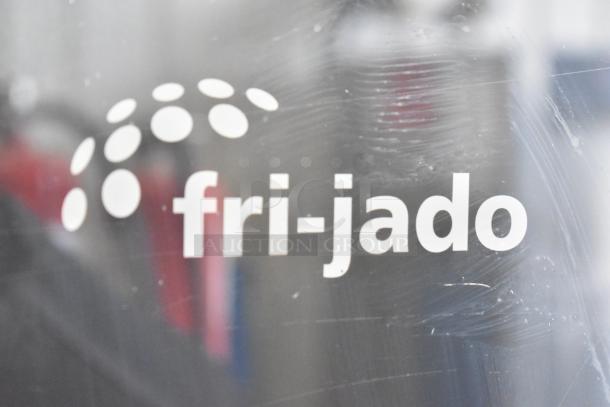 Fri-jado commercial rotisserie oven logo on glass surface, showcasing brand presence.
