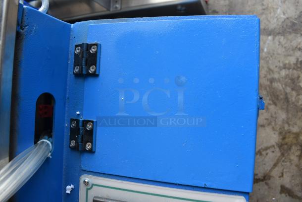 Commercial paper tube labeling machine, blue metal housing, hinge detail, suitable for 208/250 volts, 1 phase.