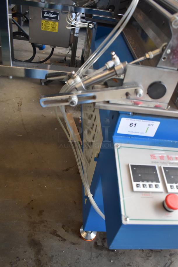 Commercial paper tube labeling machine, 208/250 volts, 1 phase, features control panel, labeling mechanism. Good condition.