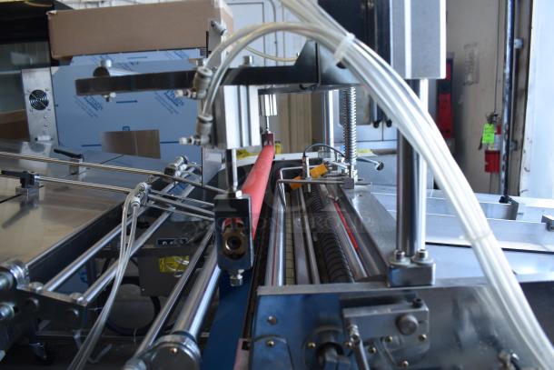 Commercial Paper Tube Labeling Machine, 208/250V, 1 Phase, in good condition, showing labeling components and metal frame.