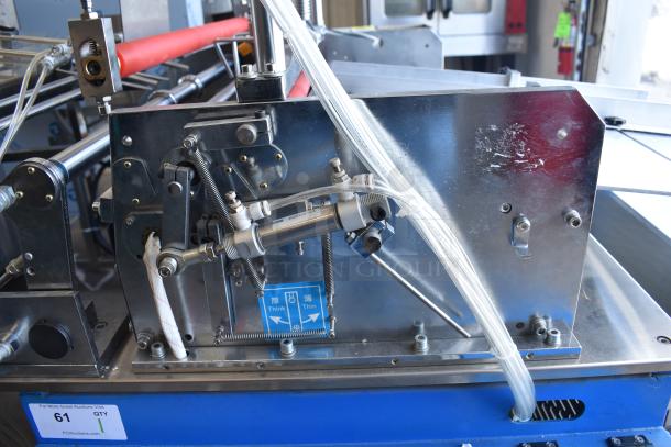 Commercial paper tube labeling machine in stainless steel, showing mechanical components and tubing. Voltage: 208/250V, 1 Phase.