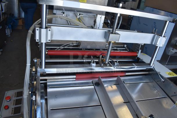 Commercial paper tube labeling machine, 208/250V, 1 phase, features red rollers, control panel with buttons, in good condition.