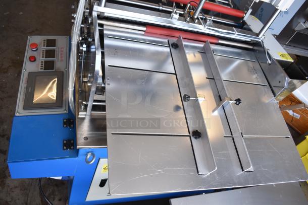 Commercial paper tube labeling machine with control panel, 208/250 volts, 1 phase, stainless steel components, in good condition.