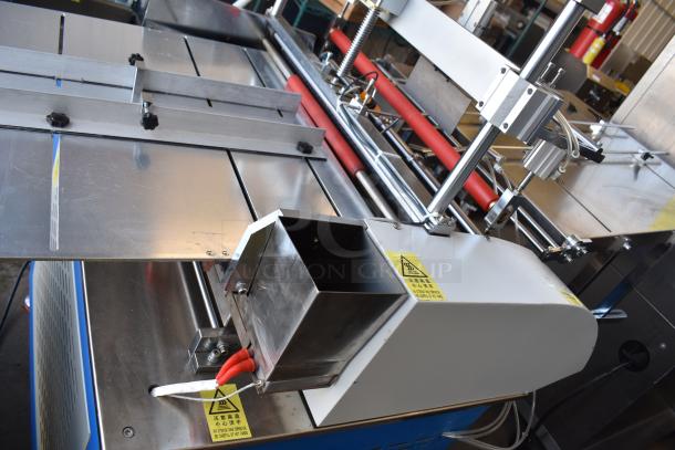 Commercial paper tube labeling machine in metal finish, 208/250 volts, 1 phase. Features stainless steel components and safety markings.