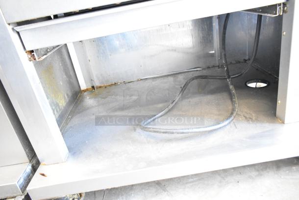 Fri-jado TDR7-P commercial rotisserie oven interior, showing signs of use, with visible electrical wiring and stainless steel construction.