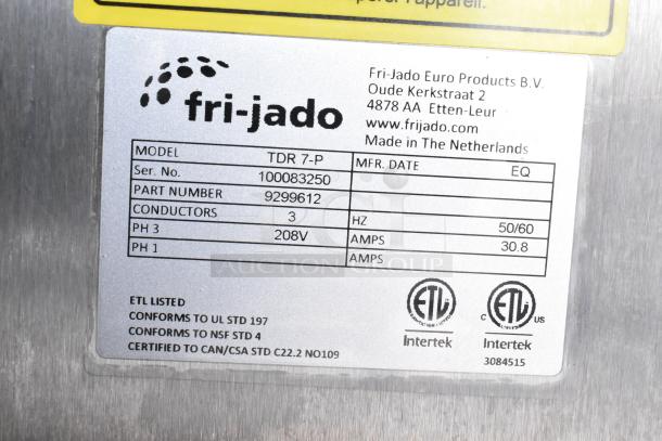 Fri-jado TDR7-P rotisserie oven label showing model, serial number, voltage, and certifications. Mounted on commercial casters.