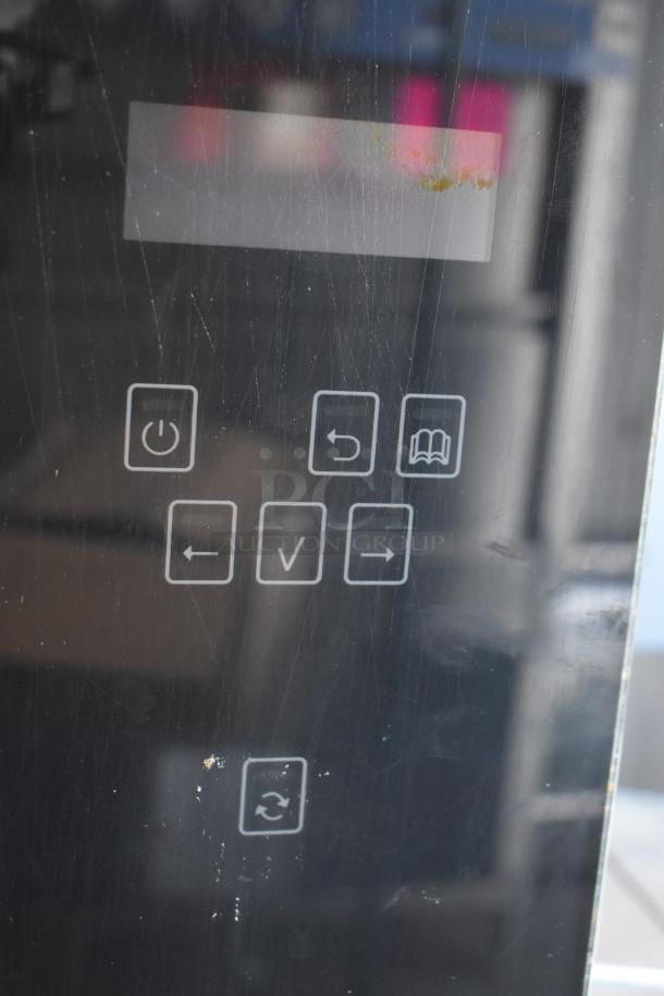Fri-jado TDR7-P electric rotisserie oven control panel; visible buttons include power, settings, and rotation.