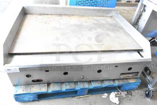 Southbend commercial countertop gas griddle, flat top, showing signs of wear, placed on a wooden pallet.