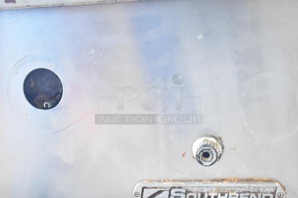 Southbend commercial gas-powered flat top griddle, stainless steel, shows wear, visible Southbend logo.