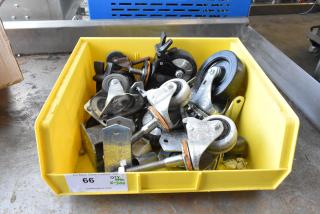 Yellow bin with 20 commercial casters, various sizes and materials, labeled "66," indicating auction lot number.