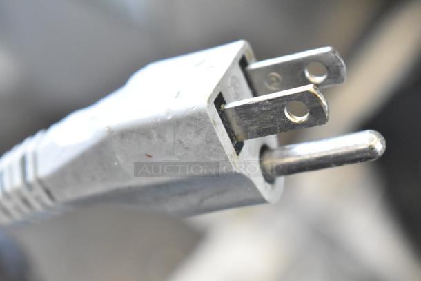 Three-prong electrical plug for Bizerba GSP H Commercial Meat Slicer, 120 volts, 1 phase, showing metal prongs.