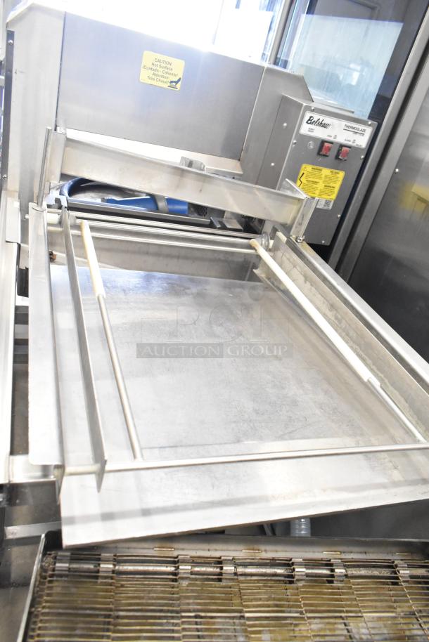 Belshaw Adamatic TG-50 stainless steel thermoglazing station on casters. Features 208V, 1 phase power. Includes caution labels.