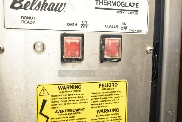 Belshaw Adamatic TG-50 Thermoglazing Station, stainless steel, commercial casters, 208V, 1 phase, warning labels visible.