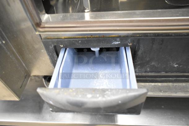 2019 Rational SCC WE 62 Combi Oven lower drawer detail, showing blue interior. Stainless steel exterior with some signs of use.