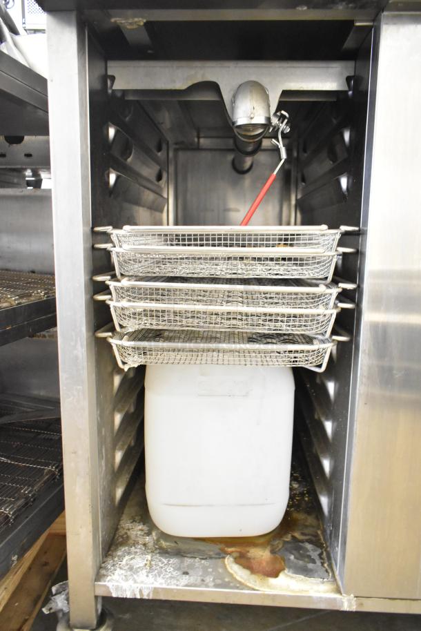 2019 Rational SCC WE 62 combi oven on double pan rack. Stainless steel, 480V, 3 phase. Visible interior with trays and residue.