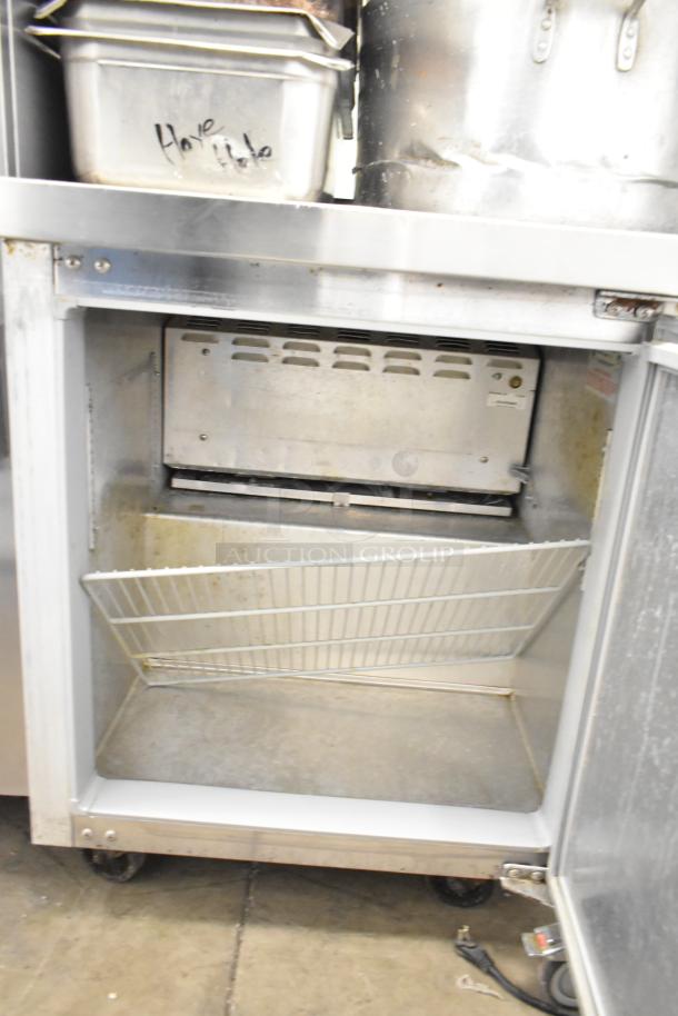 Continental SWF27 commercial undercounter freezer, single door, on casters. Includes wire shelf. Condition: used. Model SWF27.
