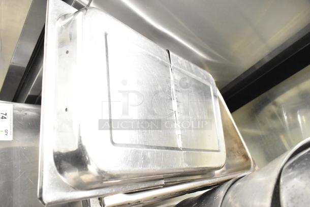 Stainless steel stock pots and drop-in bins bundle. Includes 8 items in good condition. Auction tag visible.