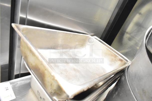 8 various kitchen items including 3 stock pots and drop-in bins. Items show signs of use, suitable for commercial kitchens.