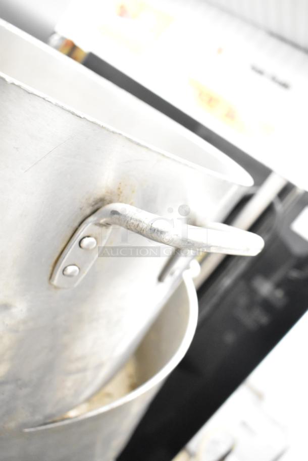 Aluminum stock pot with riveted handles, visible wear. Part of a lot including drop-in bins. Auction for 8 items.