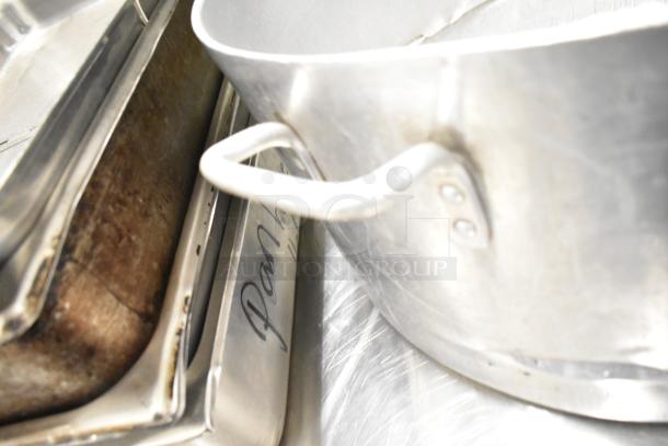 Stainless steel cookware including 3 stock pots and drop-in bins, fair condition, visible labeling on bins.