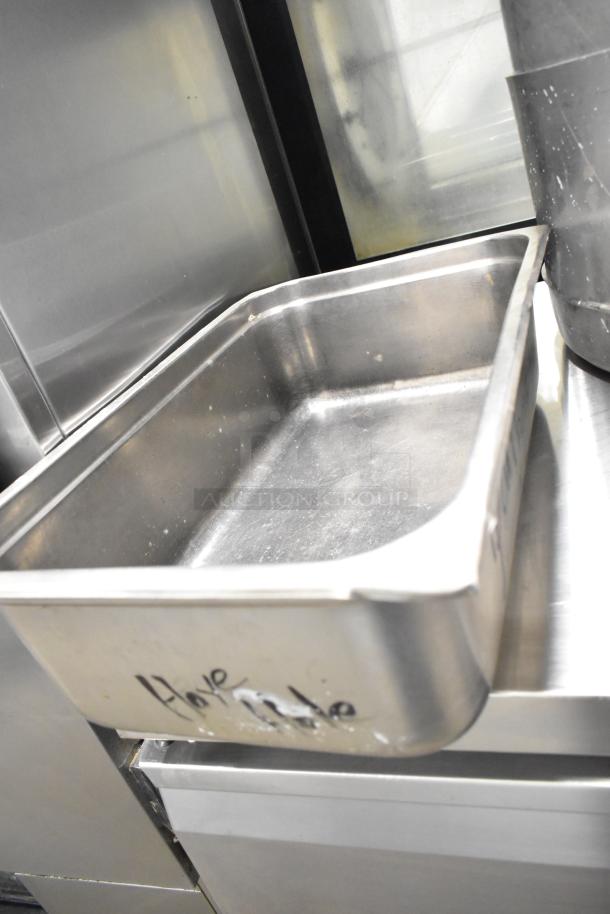 Stainless steel drop-in bin with visible handwritten marking, part of 8 mixed kitchenware items, including stock pots.