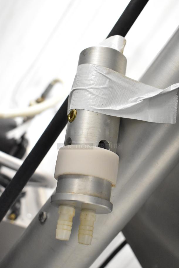 Per-fil Micro-15 floor filler machine, 125V, 1 phase, on commercial casters. Close-up of spout with duct tape for securing.