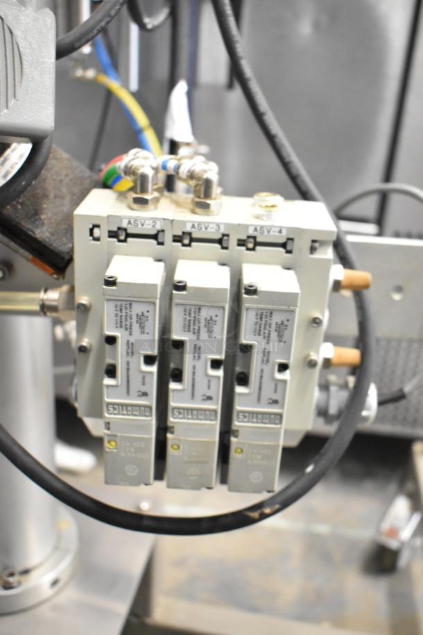 Per-fil Micro-15 floor-style filler machine on commercial casters. Features visible valves and connected cables. 125 volts, 1 phase.