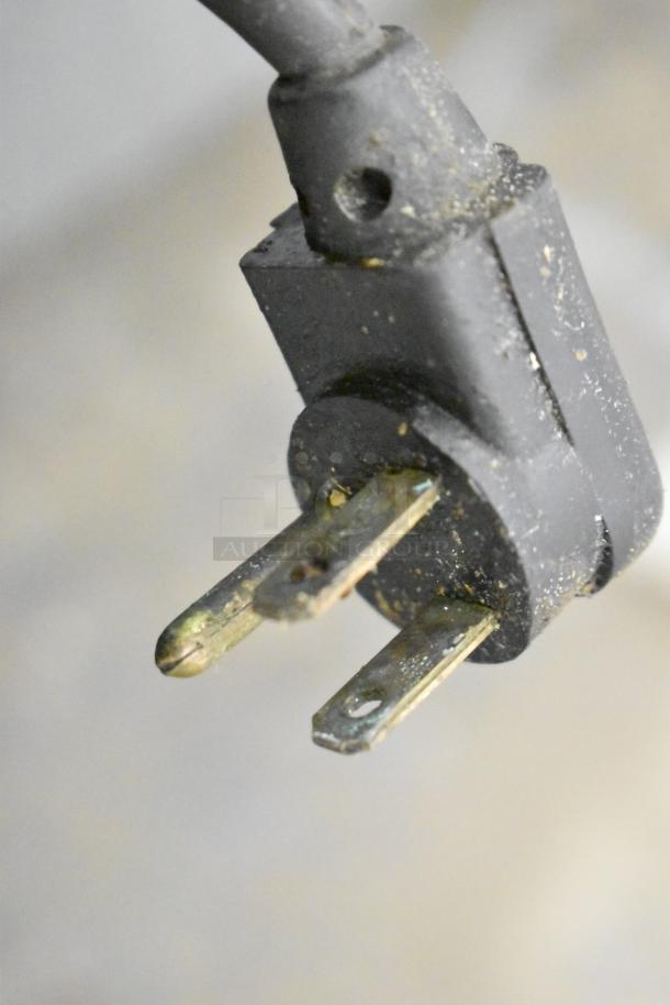 Close-up view of a plug for the 2017 True TPP-44D-2 Commercial Pizza Prep Table, slightly worn, with visible prongs.