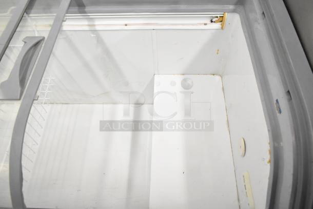 XS-500YX Commercial Novelty Ice Cream Freezer Merchandiser, 115 Volts, 1 Phase. Gray interior, sliding glass lid, visible wear.