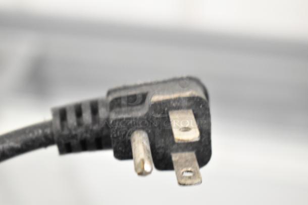 Close-up of a three-pronged power plug for the XS-500YX Ice Cream Freezer Merchandiser, 115 Volts, 1 Phase.