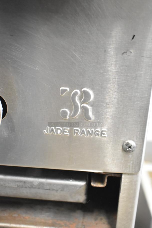 Stainless steel panel of Jade Range JSR-36B-36 with logo engraving, screws visible, indicating commercial build.