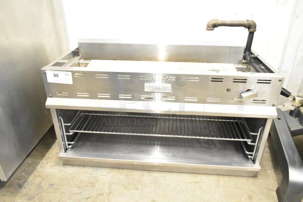 Cookline Commercial Gas Powered Cheese Melter, stainless steel, adjustable rack, used condition, model label visible.